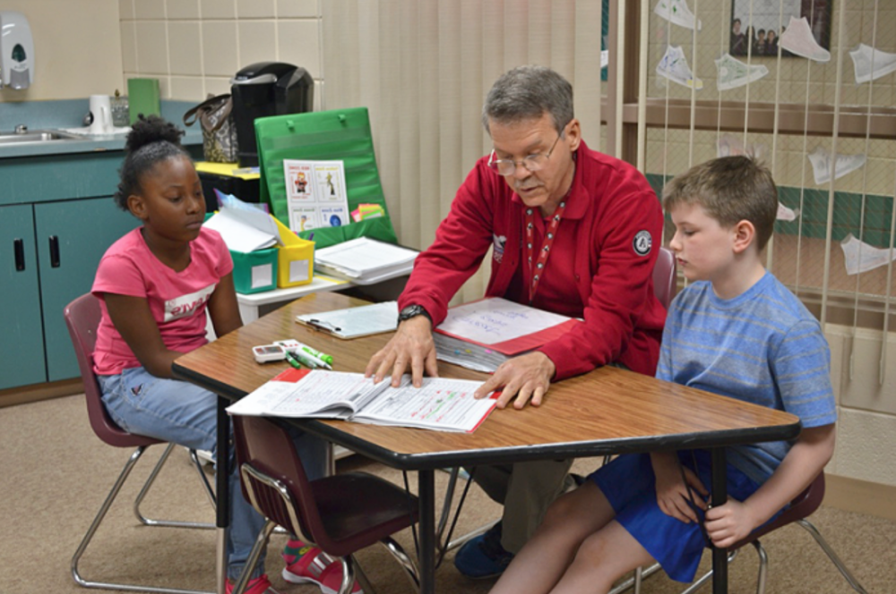 John Kidd and children in Reading Corps