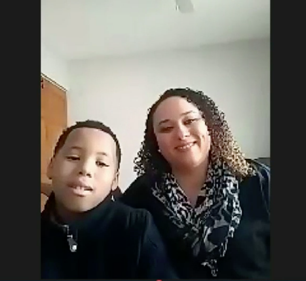 Mother and son smile during legislative testimony about Math Corps